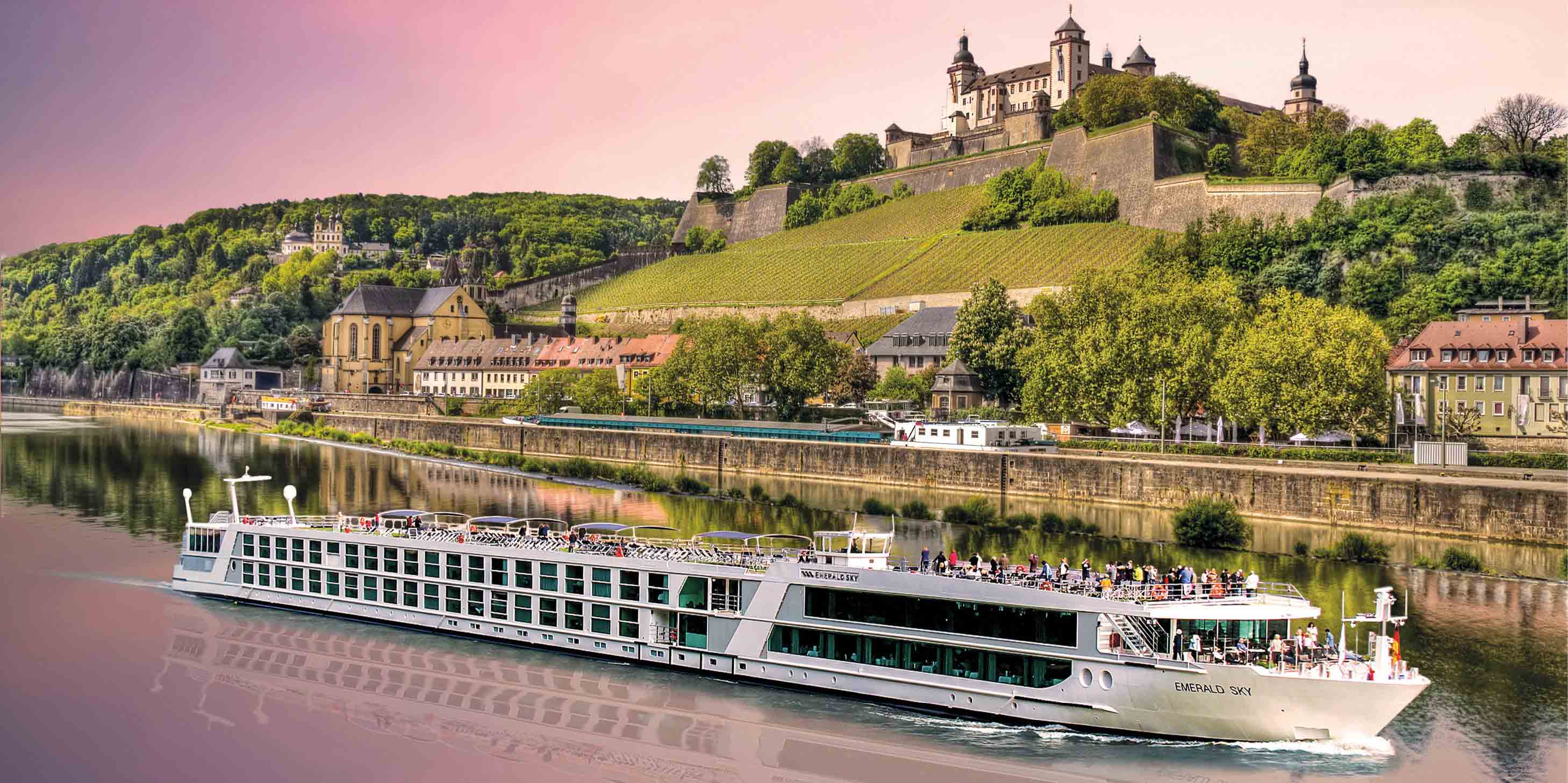 Emerald star-ship sailing past a castle on a large hill