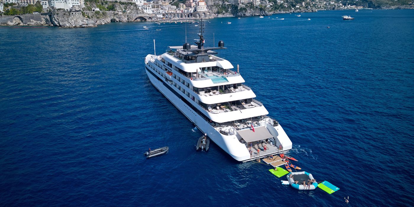 Emerald Cruises luxury yacht anchored on the Amalfi Coast with guests enjoying the water sports toys in the sea