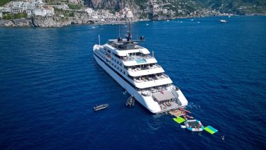 Emerald Cruises luxury yacht anchored on the Amalfi Coast with guests enjoying the water sports toys in the sea