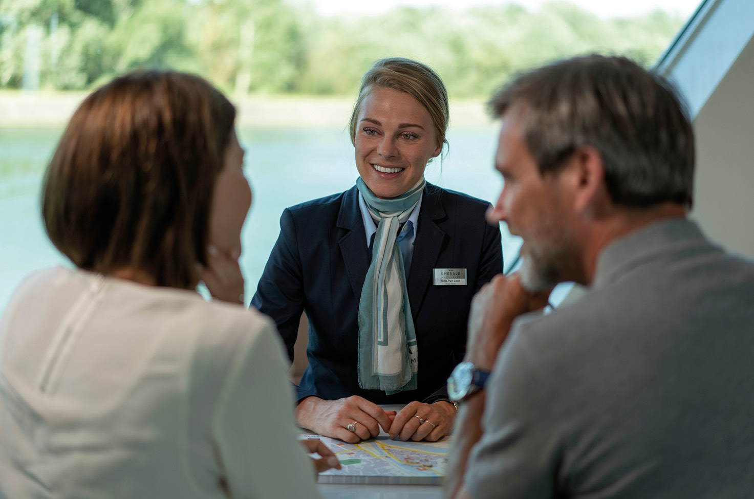 Friendly crew member helping guests on board a luxury river cruise