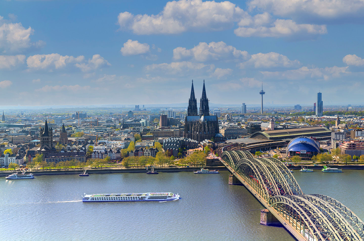 Luxury river ship sailing along the Rhine River through Cologne past the Kölner Dom