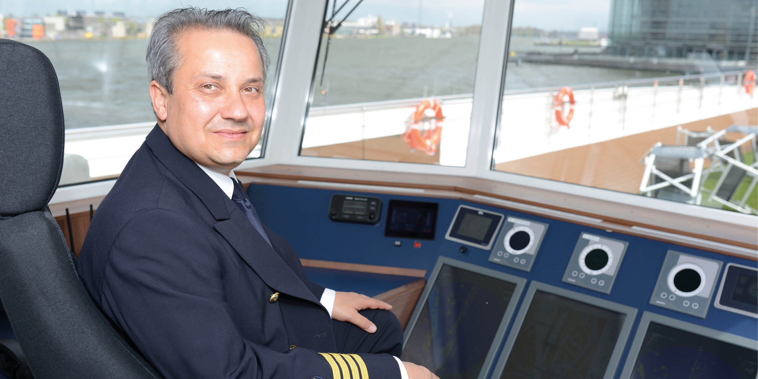 Captain sailing on board a luxury river ship 