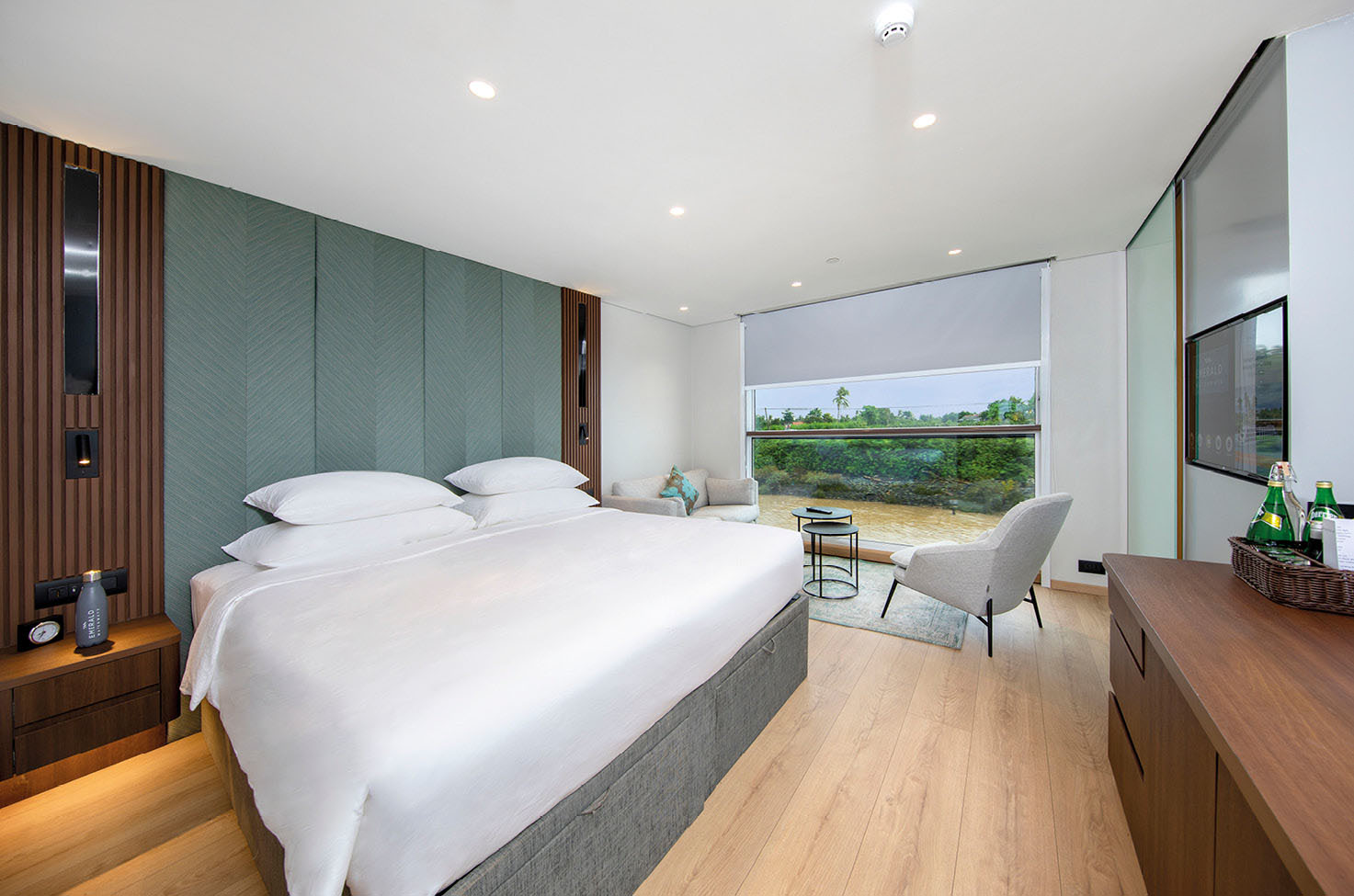 Luxury cruise ship accommodation with queen-size bed and a balcony view of the Mekong River