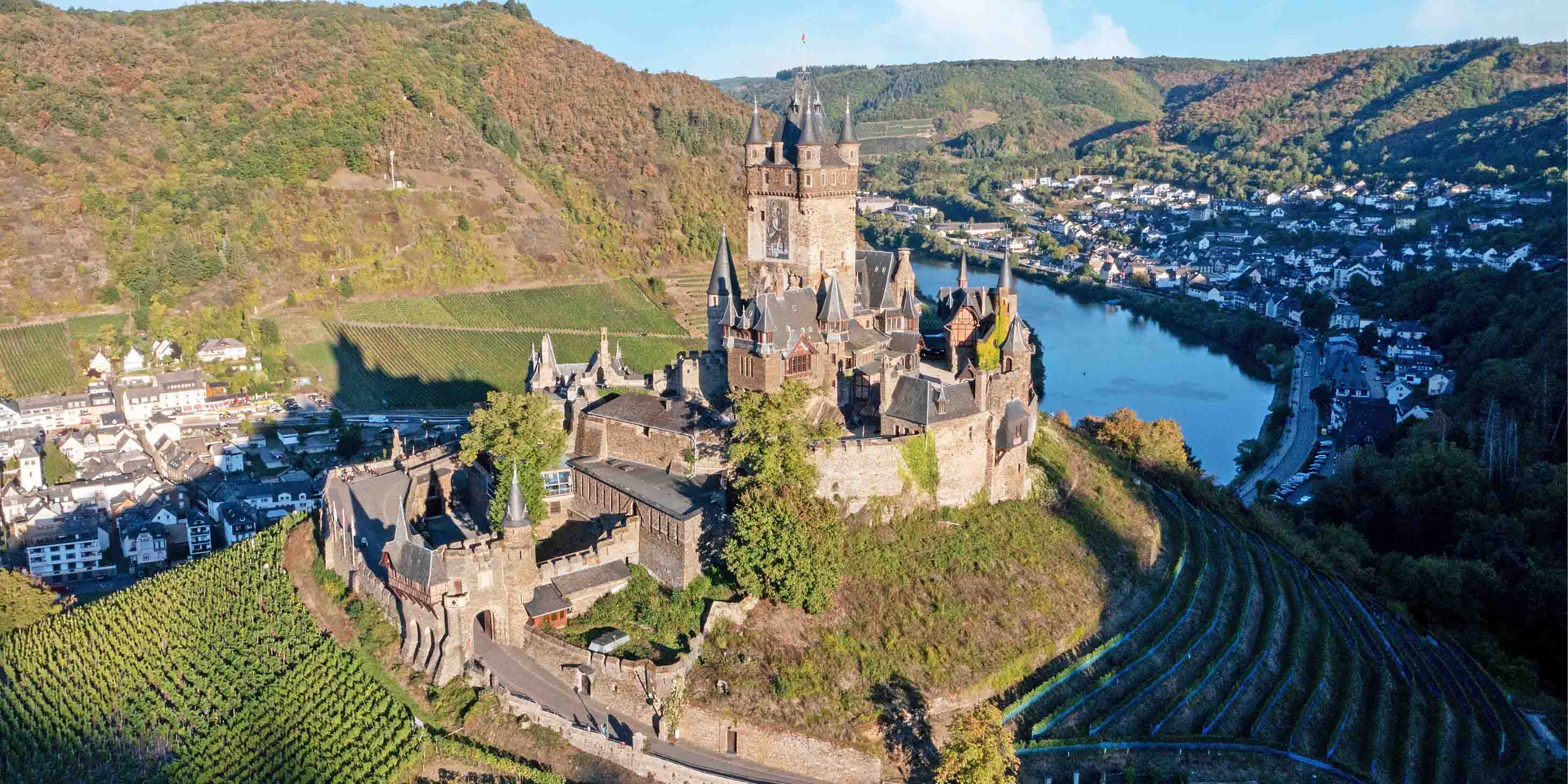 Cochem Castle and the surrounding town, green fields and the Rhine River