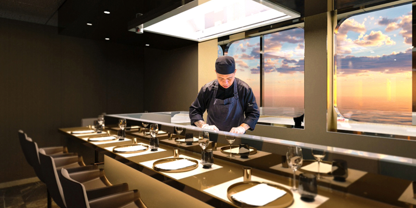 A Japanese chef preparing food at an empty private dining table under a bright light