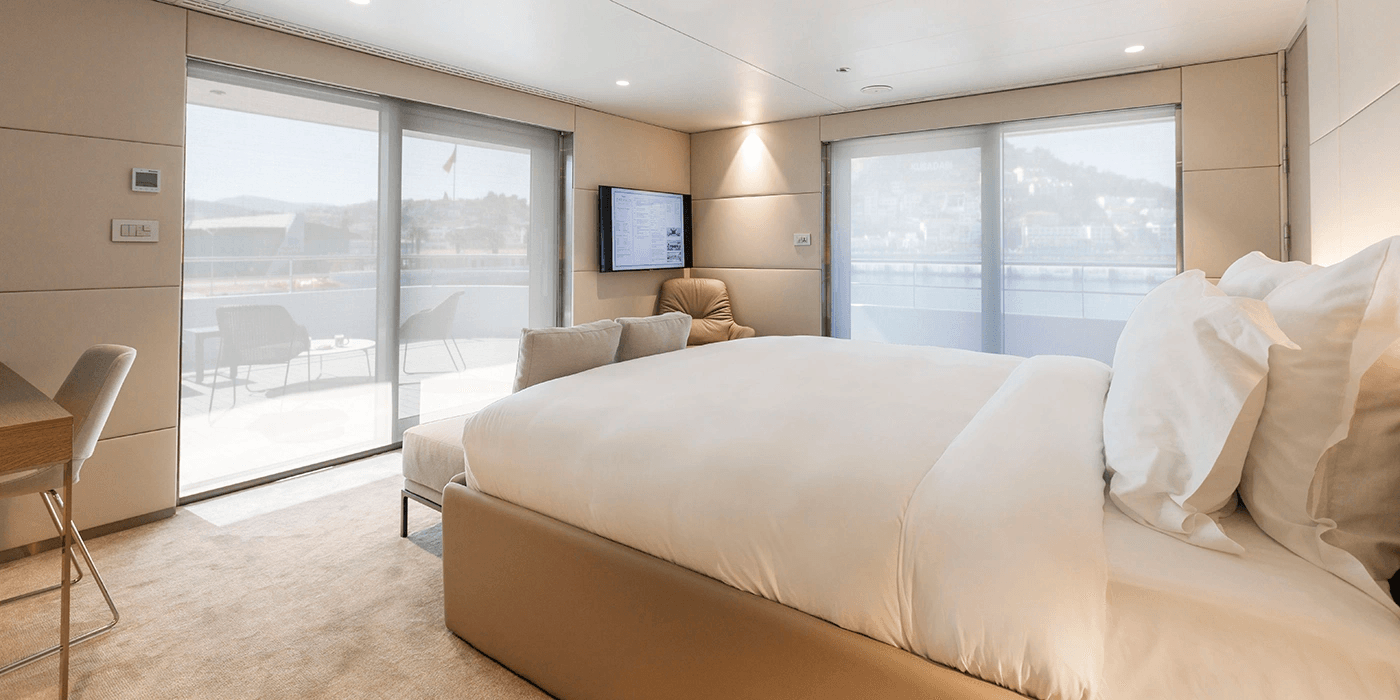 A large and spacious cabin on an Emerald Cruises yacht cruise leading out to both an outdoor terrace and balcony