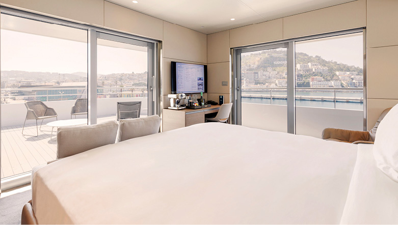 A large and spacious cabin on an Emerald Cruises yacht cruise leading out to both an outdoor terrace and balcony