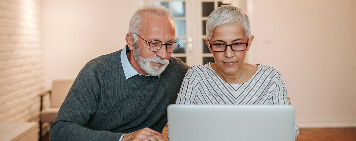 Couple sitting with laptop